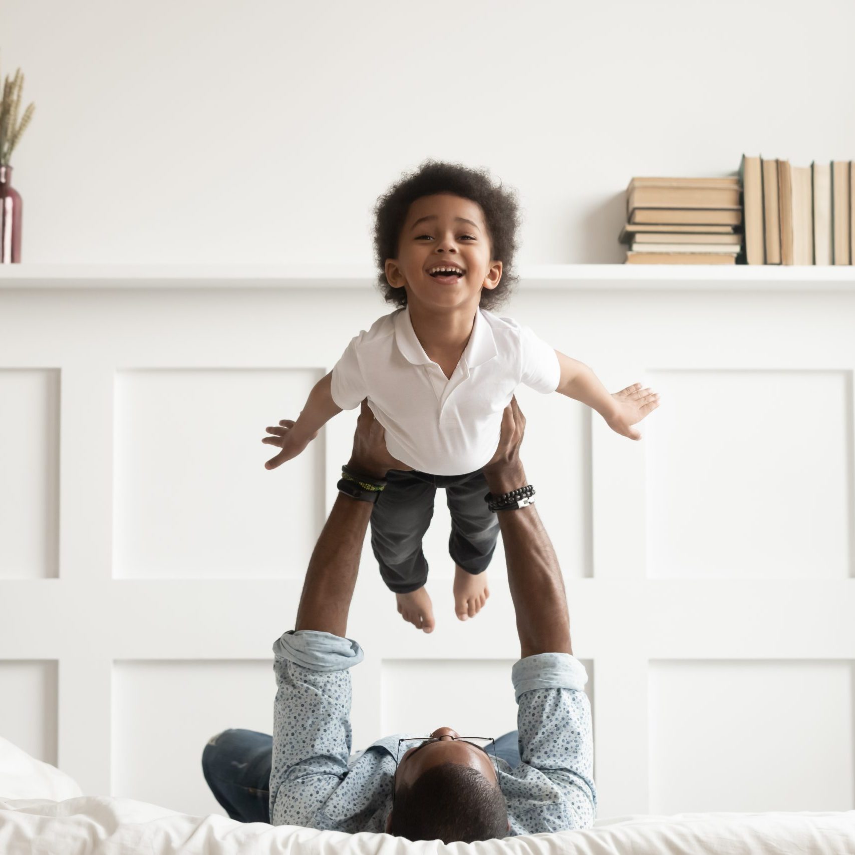 Happy,Funny,African,American,Kid,Boy,Flying,In,Fathers,Arms